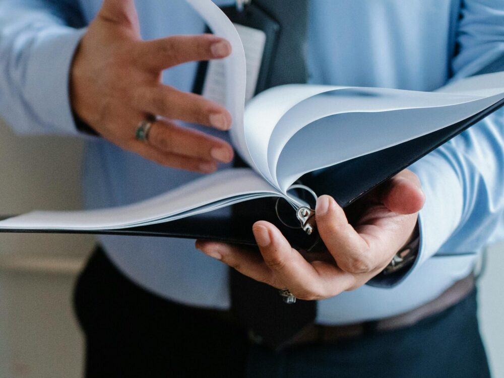 Man hold in a file that he's turning the page of