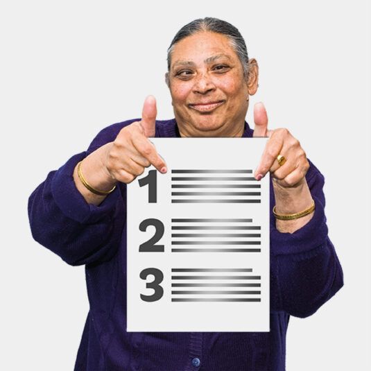Person holding piece of paper saying 1, 2, 3
