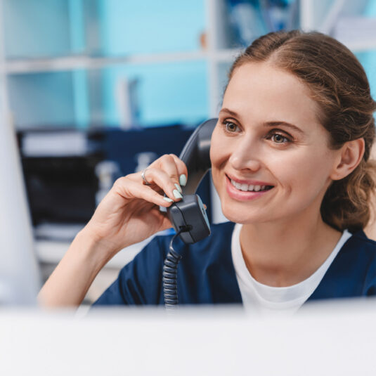 smiling female health worker on telephone