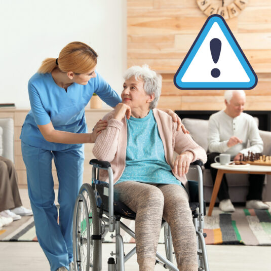 Caregiver assisting an elderly woman in a wheelchair at a care home, with a warning symbol indicating a safety or care-related alert.