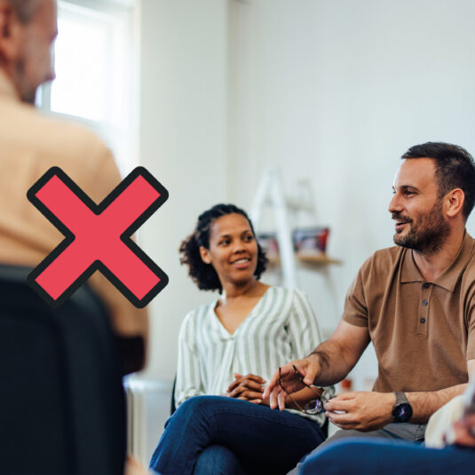 People in a discussion group with a red cross symbol