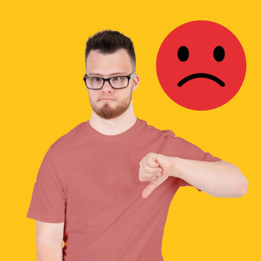 A man giving a thumbs-down with a sad face icon in the background, representing disagreement or dissatisfaction.
