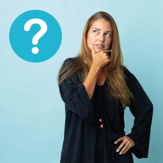 Woman looking thoughtful next to a question mark symbol, suggesting uncertainty or questions about vaccines