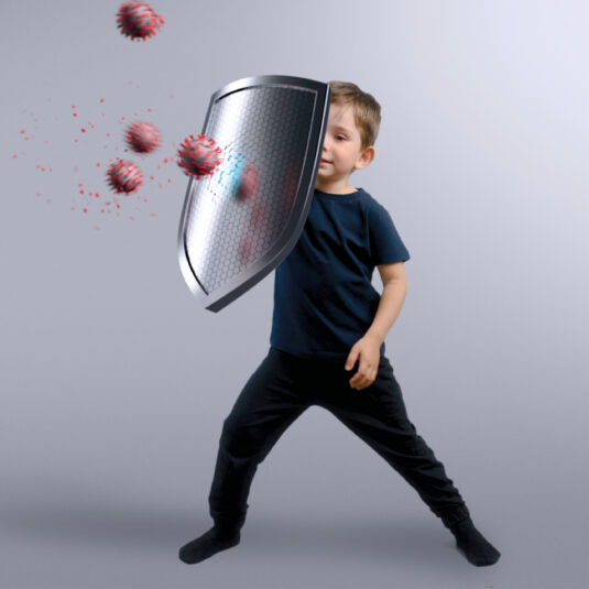 Young child using a shield to block virus particles, symbolising protection from illness.